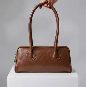 Boston bag with gold-colored zipper accents